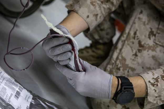 Corpsman examines a unit of blood