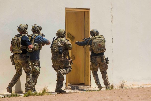 Army Green Berets enter a building during training